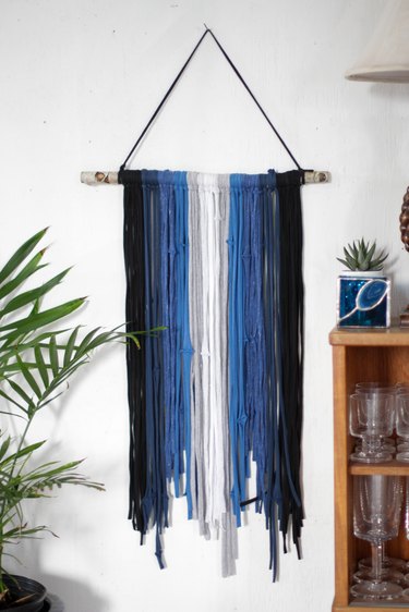 Grab some old t-shirts hanging around in your closet to create an eye-catching and stylish wall hanging.