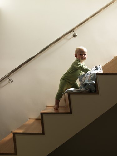 Baby boy with blanket on staircase