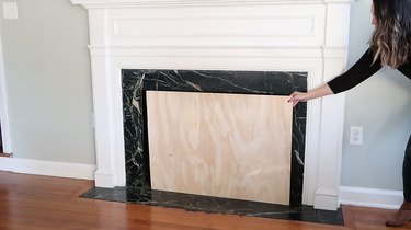Checking plywood matches size of fireplace opening