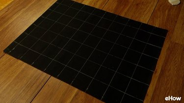 Drawing chalk guidelines for DIY mudcloth-inspired wall hanging.