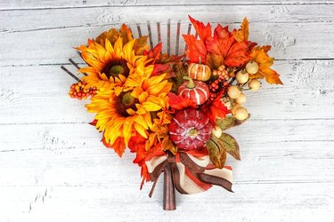 Fall door wreath with flowers and pumpkins.