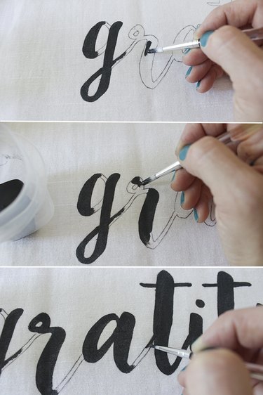 Painting letters on fabric.
