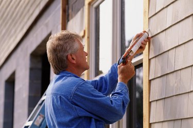 Man caulking window