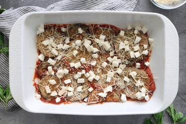Layer eggplant with sauce and cheese