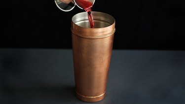 Pouring cranberry juice into cocktail shaker