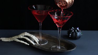 Straining drink into martini glass