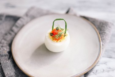 Deviled egg with smoked salmon, capers and dill