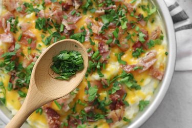 Top with bacon, chives and parsley