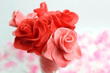 A cluster of pink and red roses made from Starburst Candy, with soft-focus rose petals in the background.