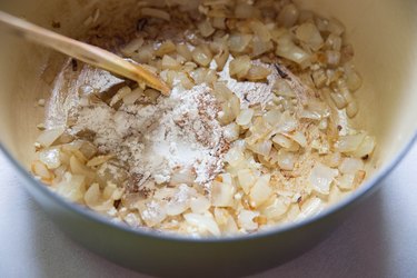 onion, garlic, and flour in a pot.