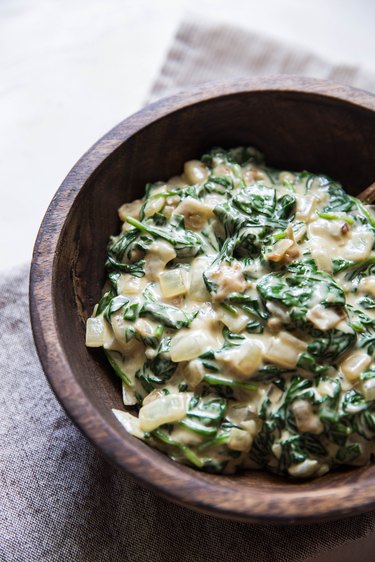 Creamed spinach in a wooden bowl.