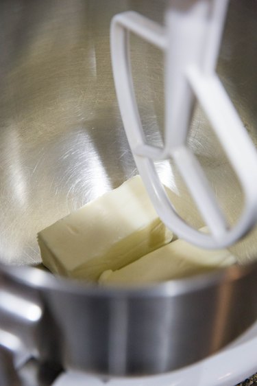Two sticks of butter in a stand mixer with paddle attachment
