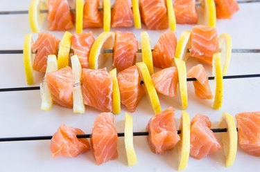 salmon and lemon skewers on a cutting board