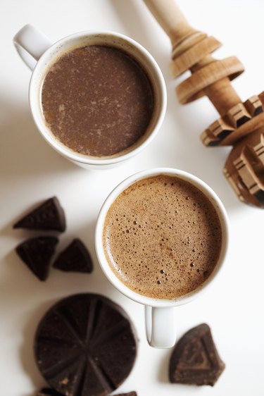 Two cups of abuelita hot chocolate with chocolate pieces, close-up