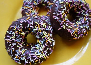 Healthy coconut flour low carb chocolate covered donuts with sprinkles.