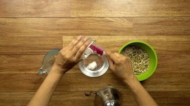 Adding coconut oil to water for healthy seed and nut crispbread crackers.