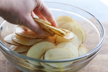 Coating potato slices in oil