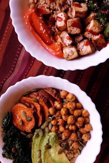 Two Buddha bowls: one with tofu broccoli and rice, another with chickpeas, avocado, quinoa, and sweet potato