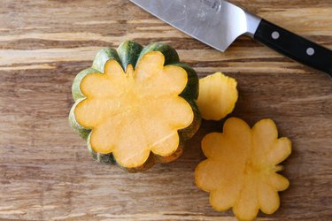 Acorn squash on a cutting board without tip or tail