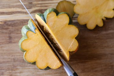 Acorn squash being cut in half