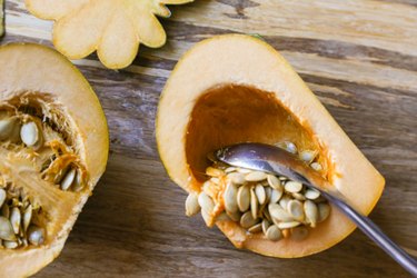 Seeds being scooped out of acorn squash