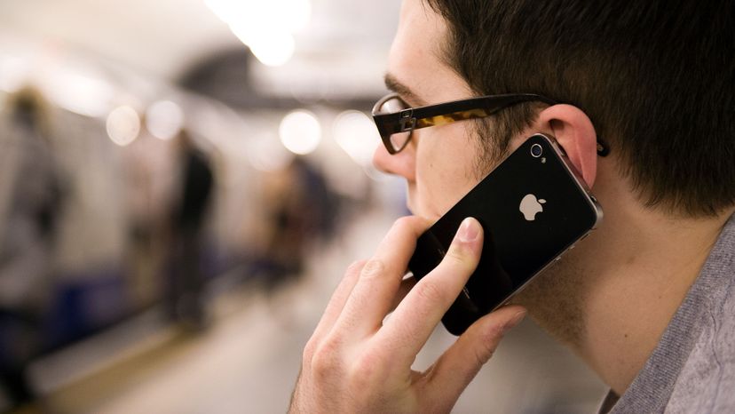 man with smartphone at train station