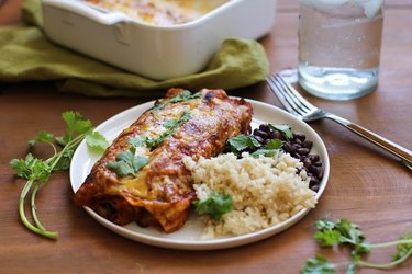 Plate of vegetarian enchiladas with beans and rice.
