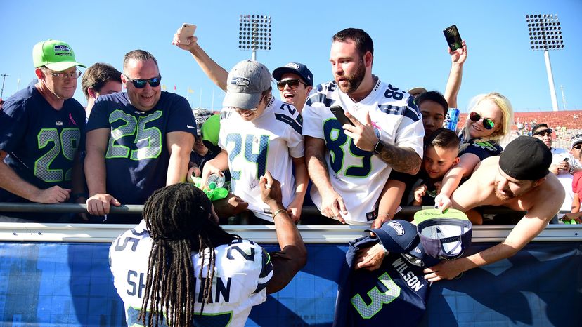 Richard Sherman (No. 25) of the Seattle Seahawks signs autographs for fans after a 16-10 win over the Los Angeles Rams at Los Angeles Memorial Coliseum on Oct. 8, 2017.   Harry How/Getty Images