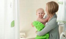 Mother and baby in bathroom