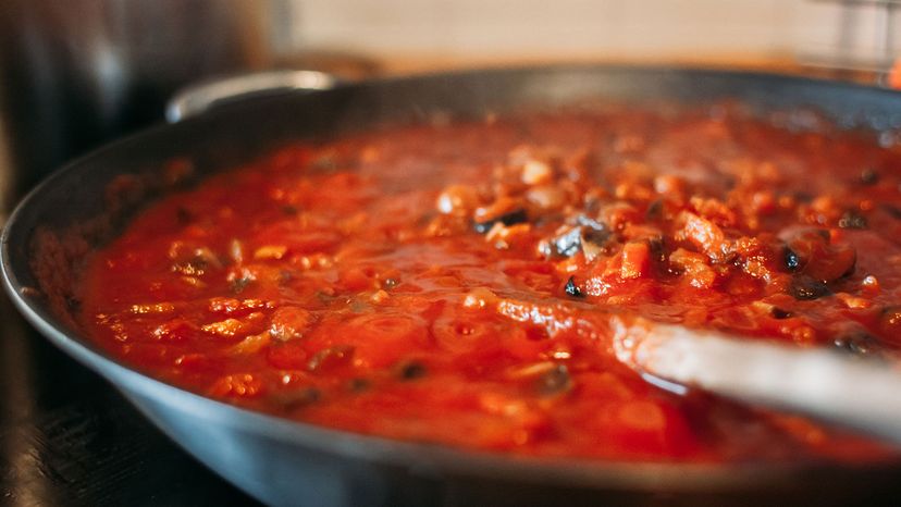 close up of tomato and vegetables sauce in a pan on the kitchen 
